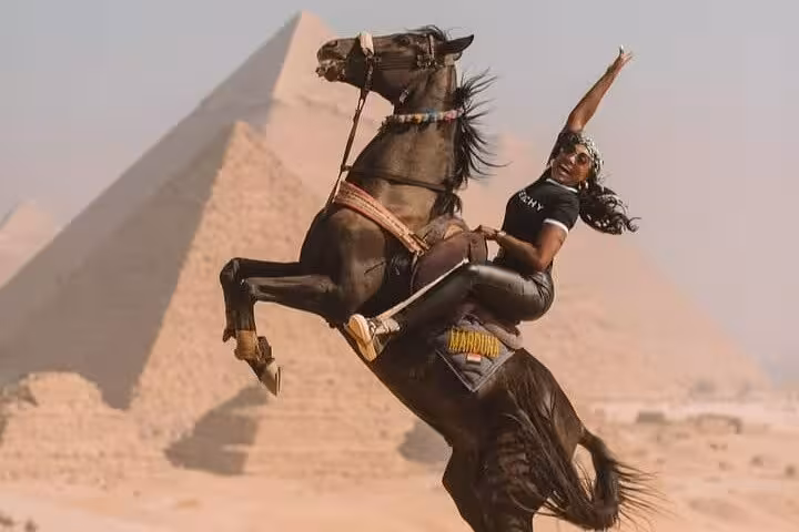 Horse jump photo at Giza Pyramids on half-day tour, rider posing with Great Pyramid in the desert