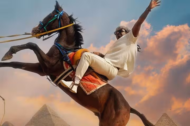 Sunset horse jump photo with Giza pyramids in background, half-day pyramids tour featuring 9-pyramids view