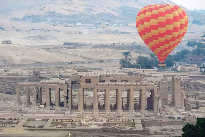 Hot air balloon over Luxor Temple complex on private overnight trip from Hurghada, sunrise aerial sightseeing