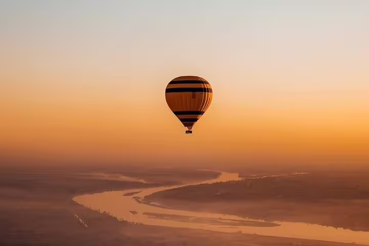 Hot air balloon over the Nile River at sunrise in Luxor, Egypt, scenic flight with round-trip transfer