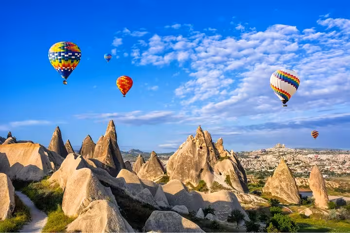 Hot air balloons over Cappadocia fairy chimneys on day trip from Istanbul hotels, panoramic Turkey view