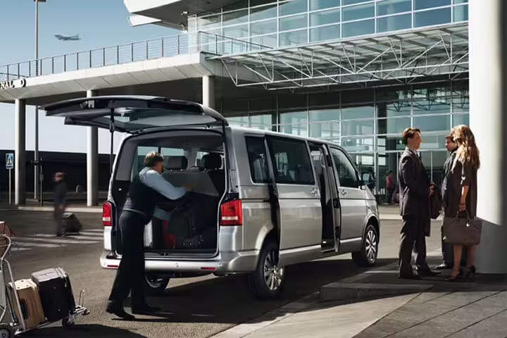 Hurghada Airport private minivan transfer with driver loading suitcases outside terminal for hotel pickup