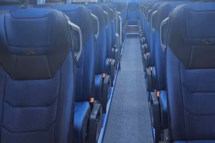 Comfortable reclining seats inside the Hurghada to Cairo bus tour coach for Pyramids, Sphinx and museum visit