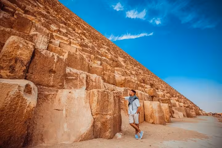 Traveler at the Great Pyramid of Giza on a Hurghada to Cairo day trip, pyramids tour for first-time visitors