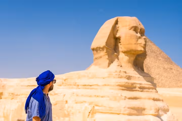 Traveler at the Great Sphinx of Giza on a Hurghada to Cairo day tour with pyramids and museum visit