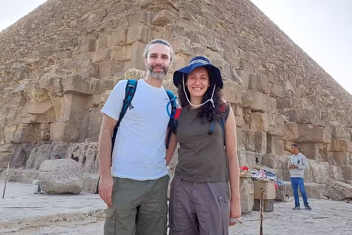 Couple posing at the Great Pyramid on Hurghada to Cairo private tour, Pyramids visit and Grand Museum