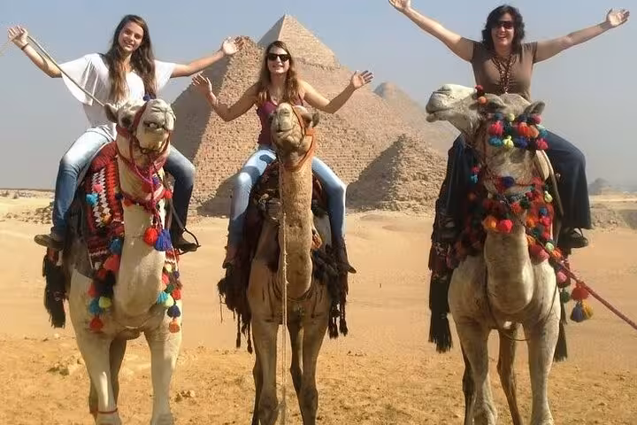 Camel ride photo at the Giza Pyramids on a Hurghada small-group Cairo excursion, plus Grand Egyptian Museum tour