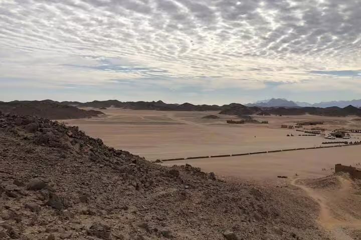 Panoramic desert dunes at sunset on quad bike safari route, leading to camel ride and Bedouin dinner camp