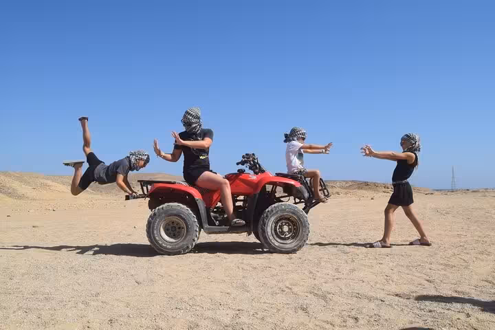 Family having fun on a red quad in Hurghada desert safari, 1-hour quad and buggy tour with dinner show