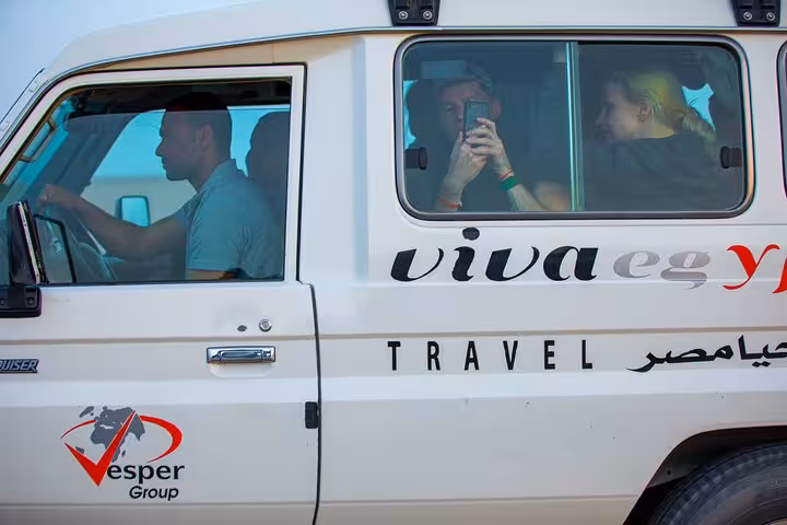 Guests riding in 4x4 Jeep during Hurghada family safari transfer for ATV quad adventure, dinner and show