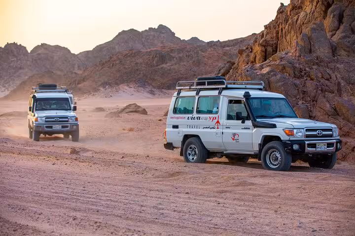 4x4 Jeeps driving through Hurghada desert mountains on family safari with ATV quad ride, dinner and show