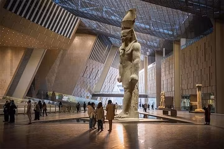 Grand Egyptian Museum atrium with colossal Ramses II statue, visited on Hurghada small-group Cairo pyramids tour