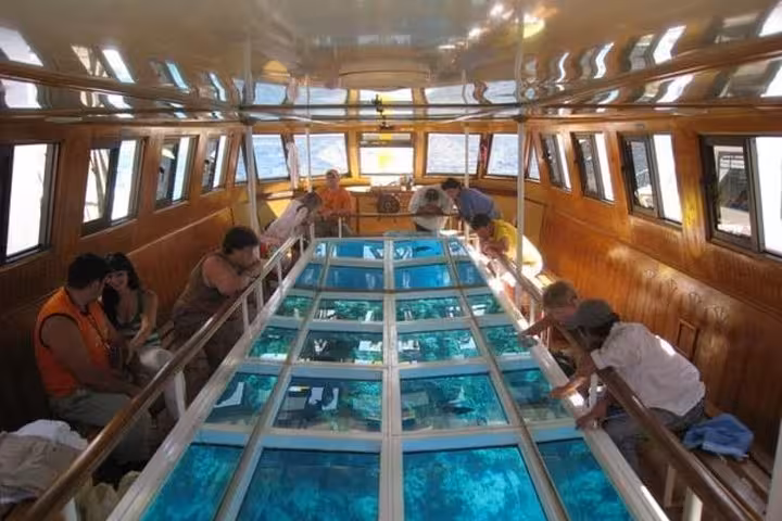 Hurghada glass-bottom boat deck with panoramic underwater views on Red Sea day trip from Luxor
