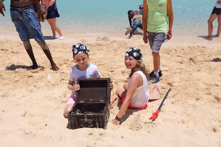 Kids in pirate bandanas with treasure chest on Orange Bay beach, Hurghada Pirates boat trip stop