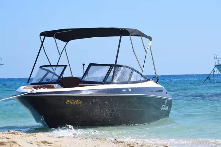 Hurghada private speedboat anchored in shallow Red Sea waters, heading to Mahmya Island with lunch