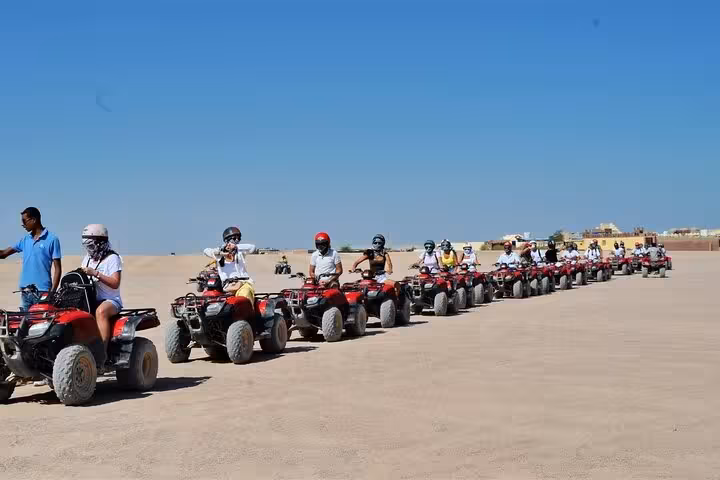 Long line of quad bikes ready for Hurghada family desert safari, 1-hour quad and buggy ride before dinner show