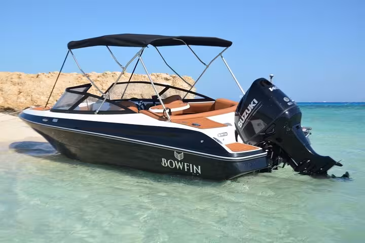 Hurghada private speedboat to Mahmya Island, docked in shallow Red Sea lagoon, lunch included tour