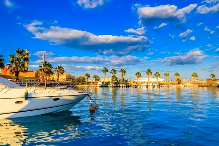 Sunny Hurghada waterfront with boats and palm trees, featured on Private Hurghada City Tour top highlights
