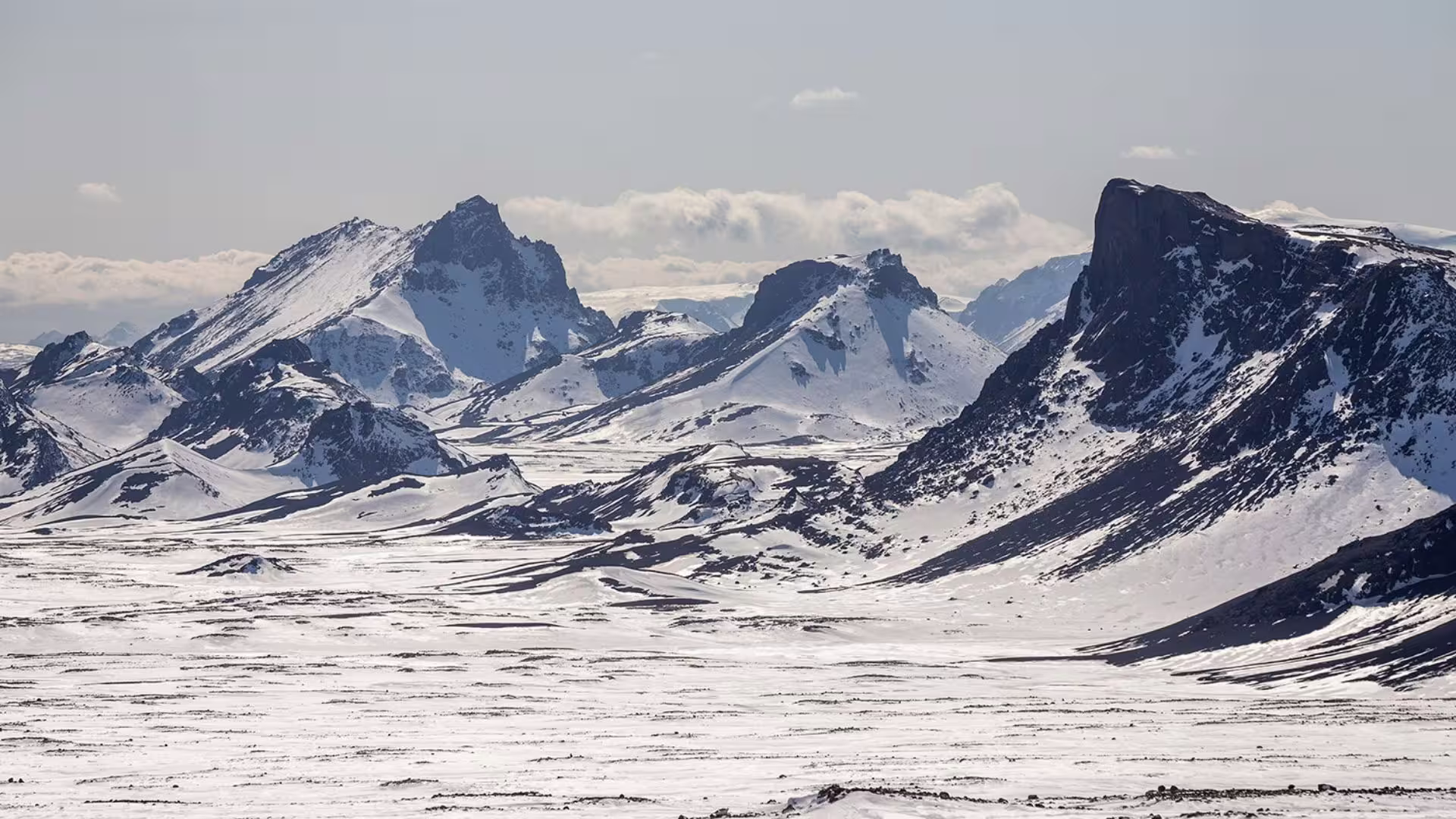 Panoramic snowcapped peaks near Langjökull on the Ice Cave and Glacier Tour from Gullfoss in a glacier monster truck