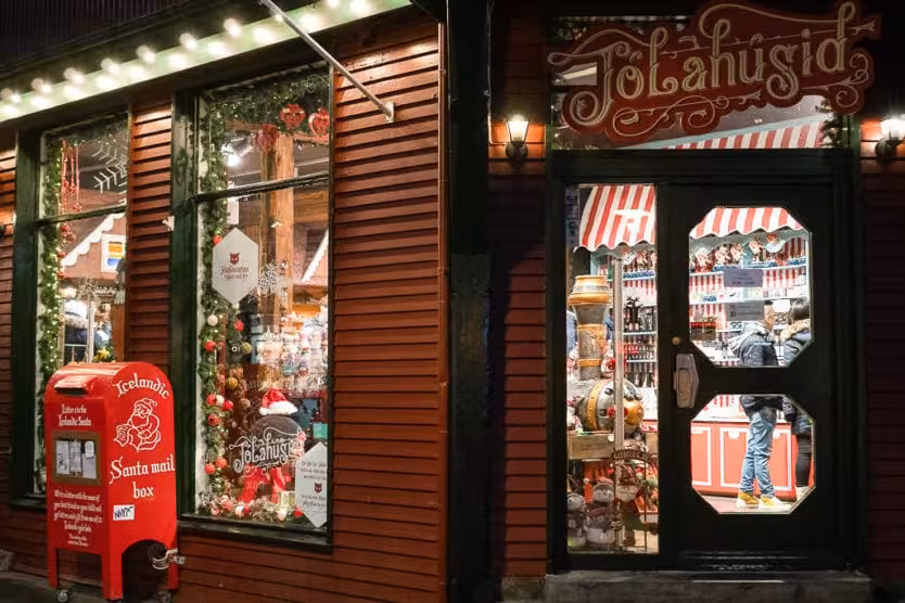 Festive storefront with Christmas decorations and Santa mail box in Iceland for Viking women winter adventure.
