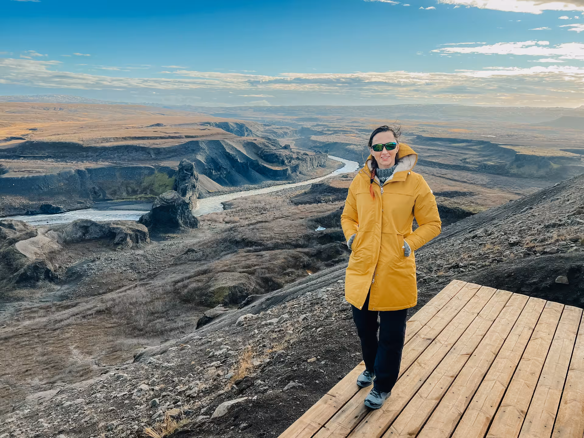 Traveler at a canyon viewpoint above a winding river, epic panorama on Iceland Adventure Diamond Circle Tour
