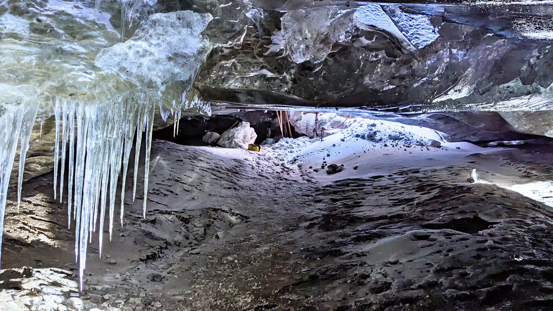 Iceland ice cave interior with icicles and snowy floor on glacier tour from Gullfoss in a monster truck