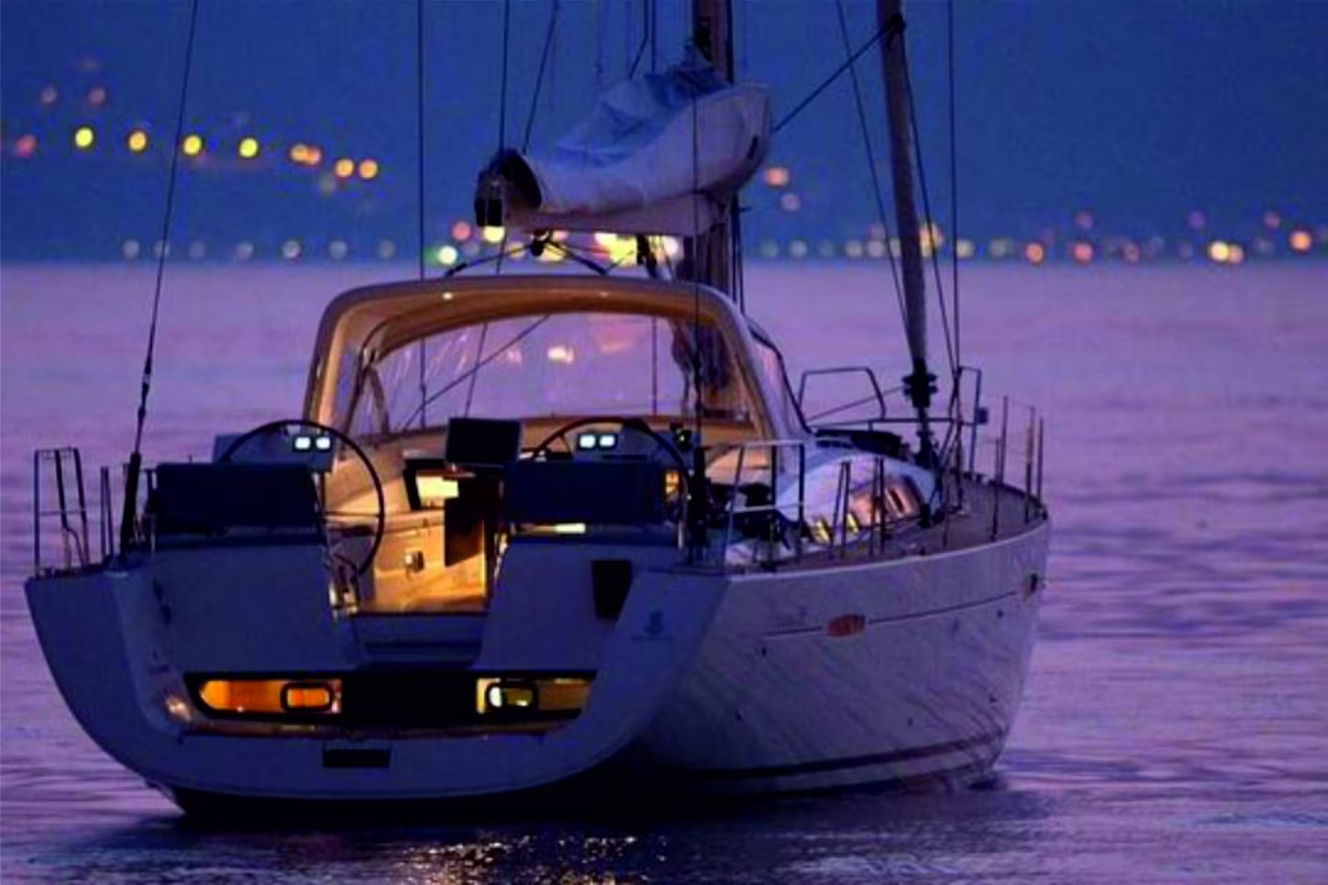 Illuminated sailboat on the Tagus River at dusk, part of a Lisbon night river cruise experience