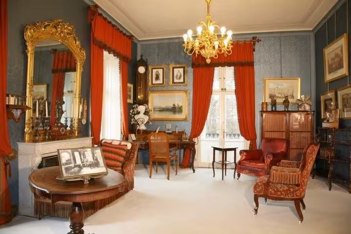 Elegant Imperial Villa Bad Ischl sitting room with antique furniture and red drapes, Salzburg day trip stop