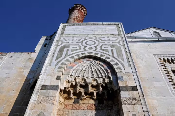 The historic Isa Bey Mosque, surrounded by lush gardens, featured on the Ephesus Small Group Tour from Izmir.