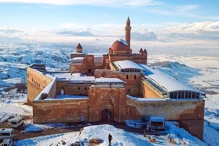 Snowy Ishak Pasha Palace in Dogubeyazit with Mount Ararat views, highlight of private all-inclusive 3-day tour