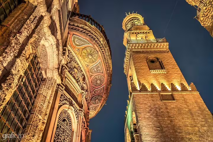 Illuminated minaret and ornate mosque facade in Islamic Cairo on Alexandria to Port Said return tour