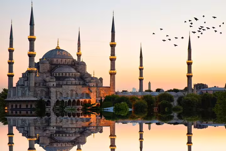 Experience the breathtaking beauty of Istanbul's Blue Mosque at sunset, reflecting on tranquil waters.