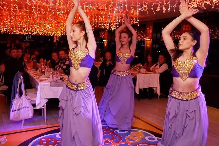 Belly dancers entertain guests during Istanbul Bosphorus dinner cruise Turkish night with private table