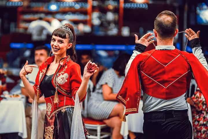 Folk dancers in traditional costumes entertaining guests on Istanbul Bosphorus dinner cruise Turkish night