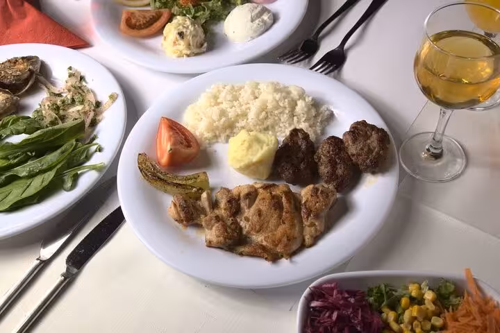 Grilled Turkish dinner with rice and kebab served at private table on Istanbul Bosphorus dinner cruise