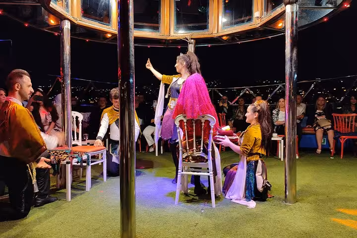 Turkish night show on Istanbul Bosphorus dinner cruise with traditional performers and audience seating on deck