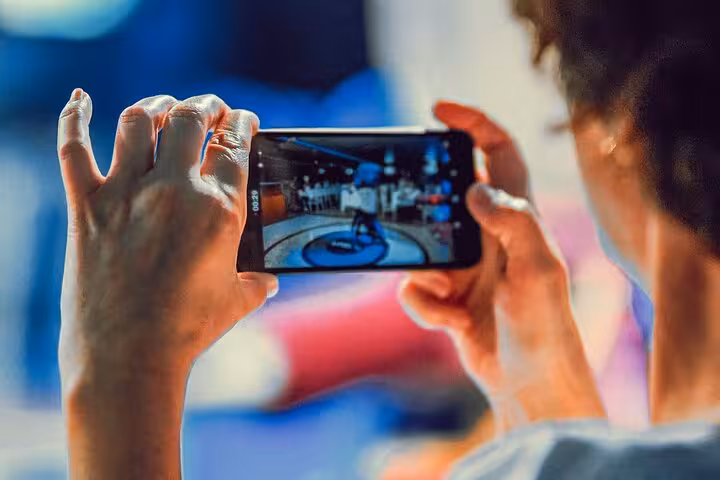Guest filming live Turkish night dance show on smartphone during Istanbul Bosphorus dinner cruise experience