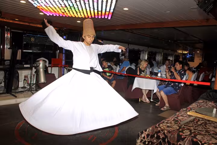 Whirling dervish dancer performing Turkish night show onboard Istanbul Bosphorus dinner cruise