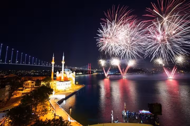 Bosphorus Bridge fireworks over Ortakoy Mosque on Istanbul New Year’s Eve dinner cruise party