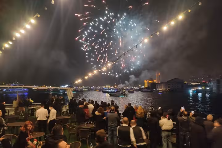 New Year’s Eve fireworks over the Bosphorus as guests watch from an Istanbul dinner cruise party deck