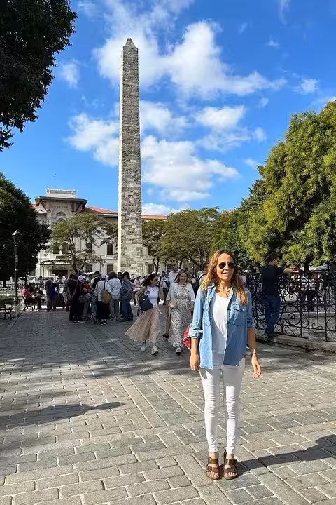 Traveler at Istanbul Sultanahmet Obelisk on Spanish tour, iconic Old City landmark in 6-day Istanbul Cappadocia package