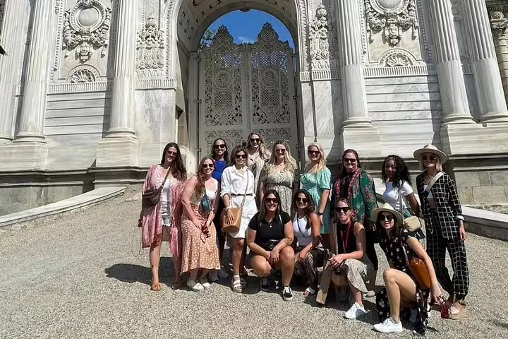 Group of tourists posing at the grand entrance of Dolmabahçe Palace during an Istanbul guided private tour.