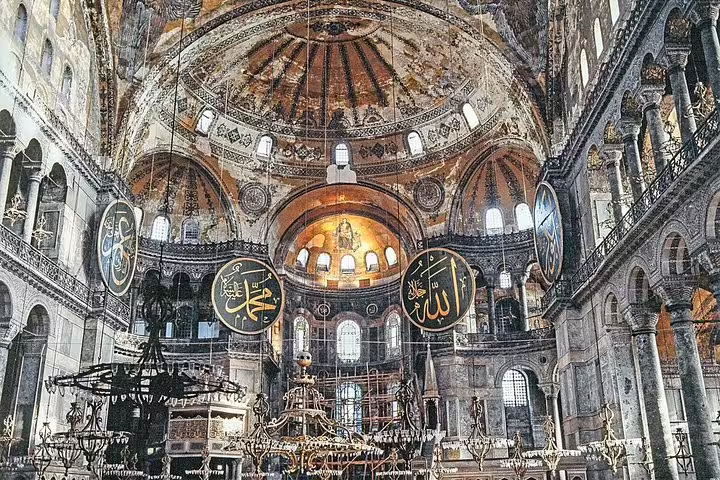Hagia Sophia interior in Istanbul with grand dome and calligraphy, highlight of 8-day Turkey flight tour