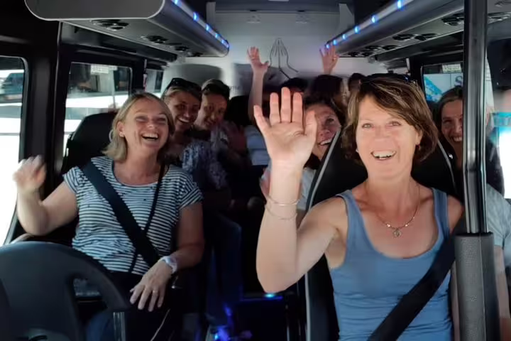 Smiling group waving in a tour van on the private Istanbul to Lake Sapanca and Maşukiye village trip