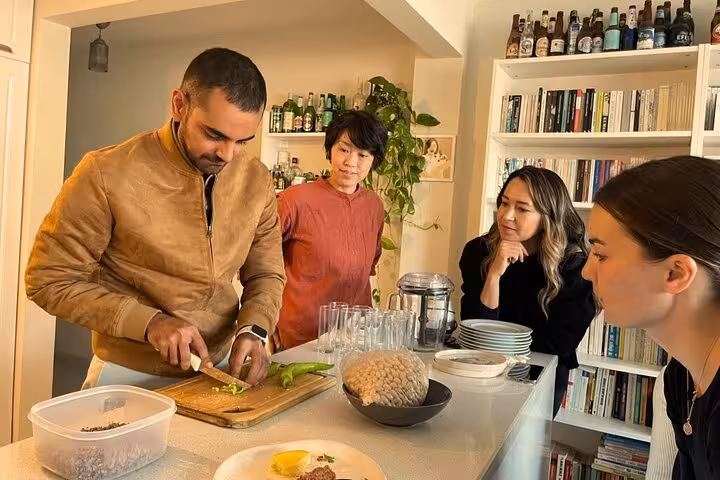 Local host teaches chopping peppers in Istanbul city center home cooking experience with Turkish meze prep