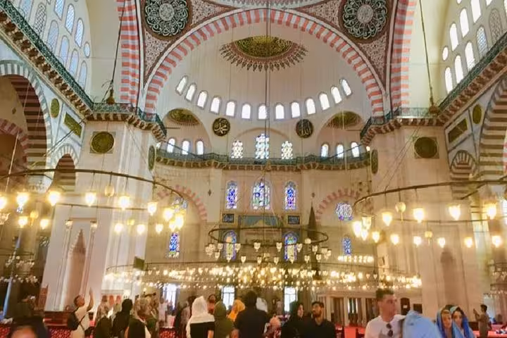 Inside Istanbul mosque with grand dome and chandeliers on a private guided tour with licensed guide and vehicle