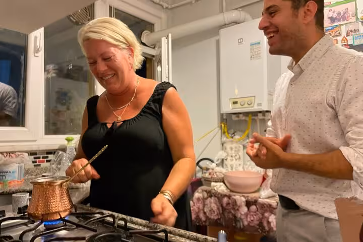 Guests cook Turkish coffee in a local Istanbul home kitchen, learning cezve brewing and tasting with hosts