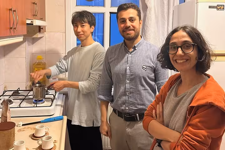 Guests cook Turkish coffee on a stovetop with local hosts during an Istanbul home tasting experience