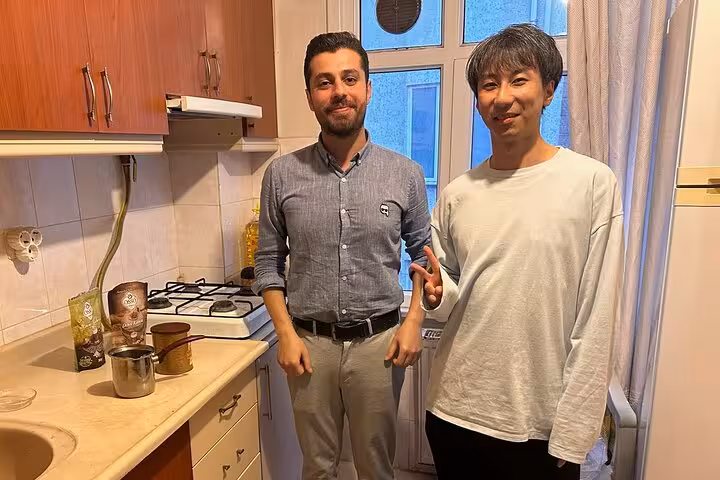 Local host welcomes guests in an Istanbul kitchen during Turkish coffee cooking and tasting at home experience