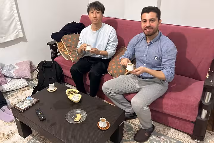 Guests sip Turkish coffee in a local Istanbul home during an authentic cooking and tasting experience